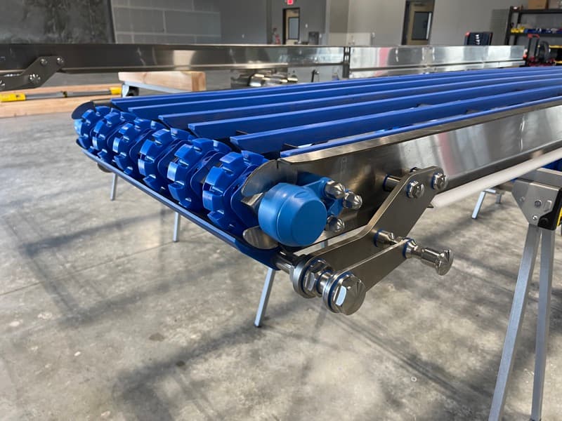 Sanitary flat-top belt conveyor with FDA-approved blue urethane belting and TIG-welded stainless steel frame