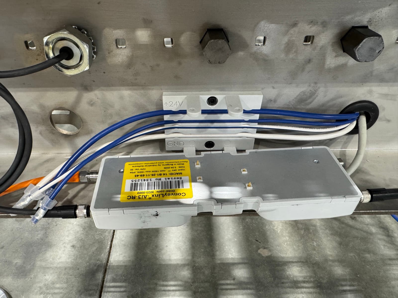 PulseRoller ConveyLinx drive card mounted under a stainless MDR conveyor frame with sealed 24V connections